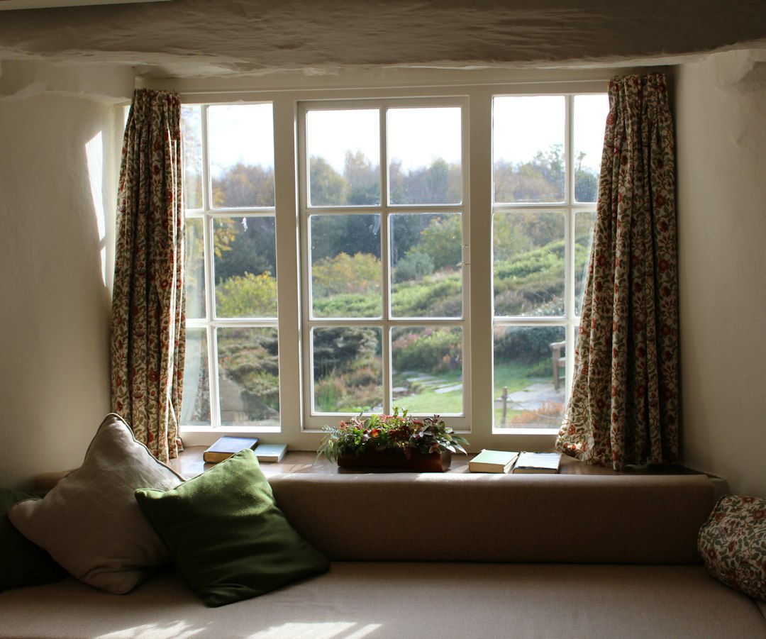 Large sunlit windows overlooking a green garden
