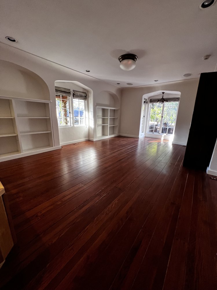 Living room with polished wood floors after Maid4You pre-staging cleaning